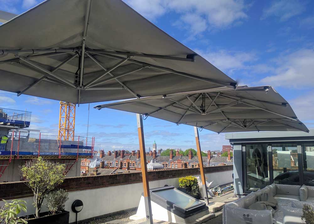 Hurricane cantilever on rooftop London Giant Cantilever Side Arm Side Post Umbrellas in London