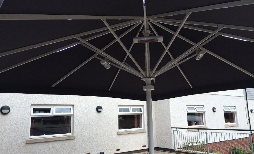 Black and silver umbrella with heating system at a care home