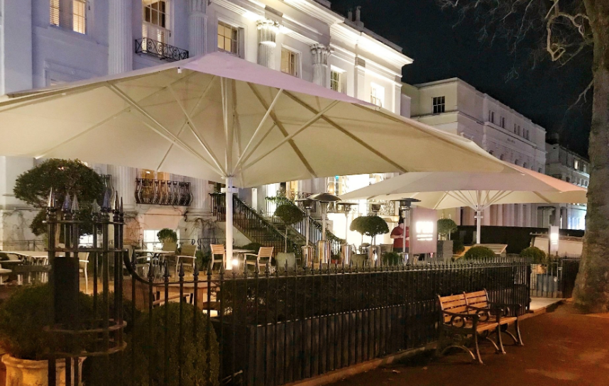 Extremely large white 9x8m umbrellas outside hotel and bar