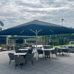 Giant parasols for hospitality sector Large umbrella over outdoor sitting area at a health club in Surrey